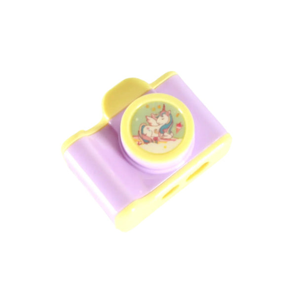 Camera-shaped manual pencil sharpener in pastel purple and yellow with unicorn design, compact and lightweight for kids and office use.